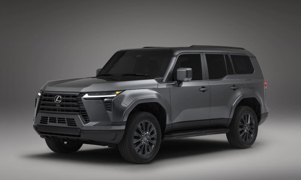 Lexus GX in gray, side three-quarter view under showroom lighting