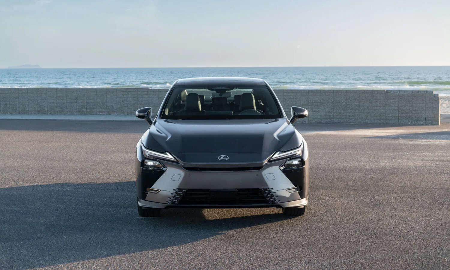 Lexus ES 350h in Cloudburst Gray, head-on front view by the sea wall