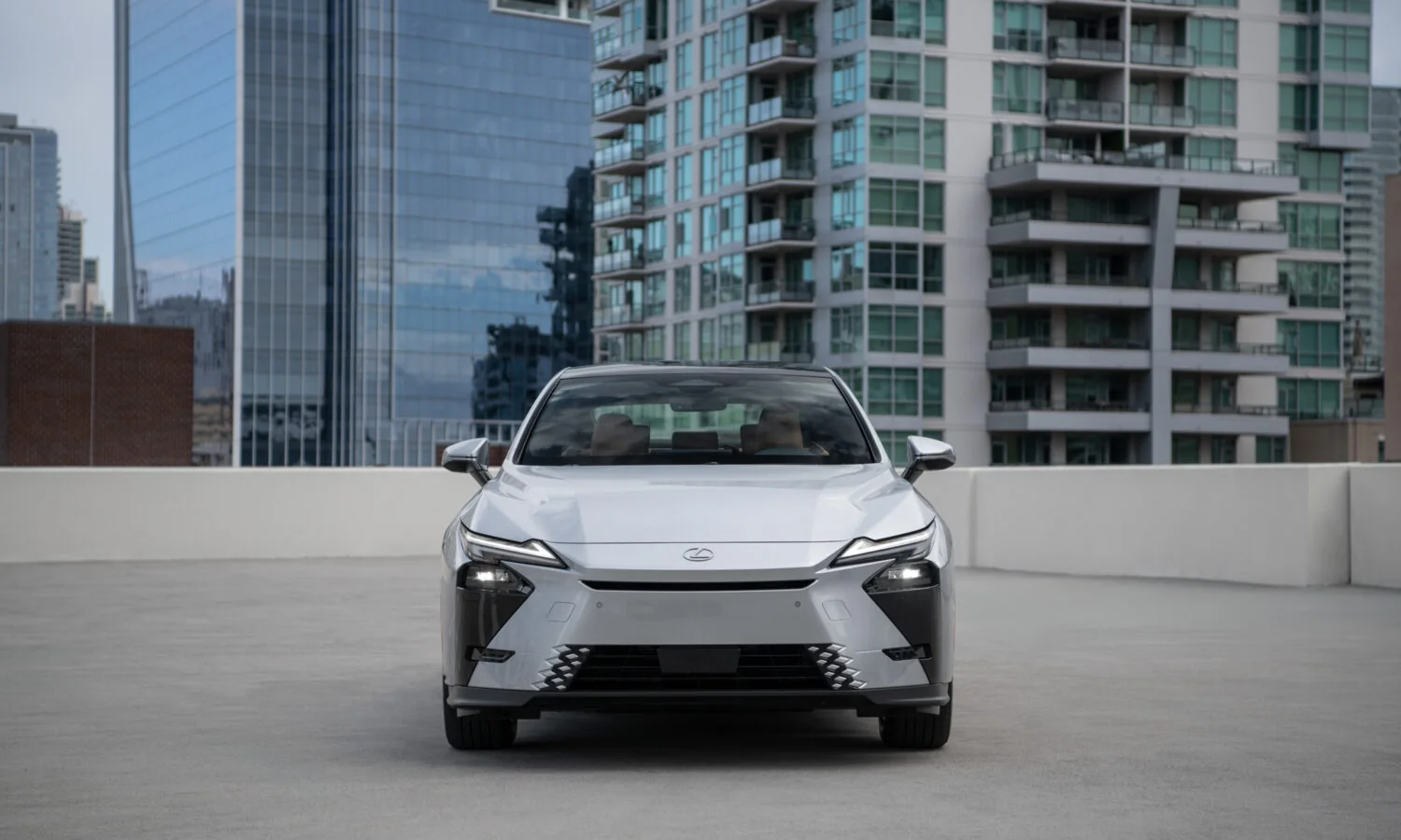 Lexus ES 350h in Iridium silver, head-on front view on a rooftop deck