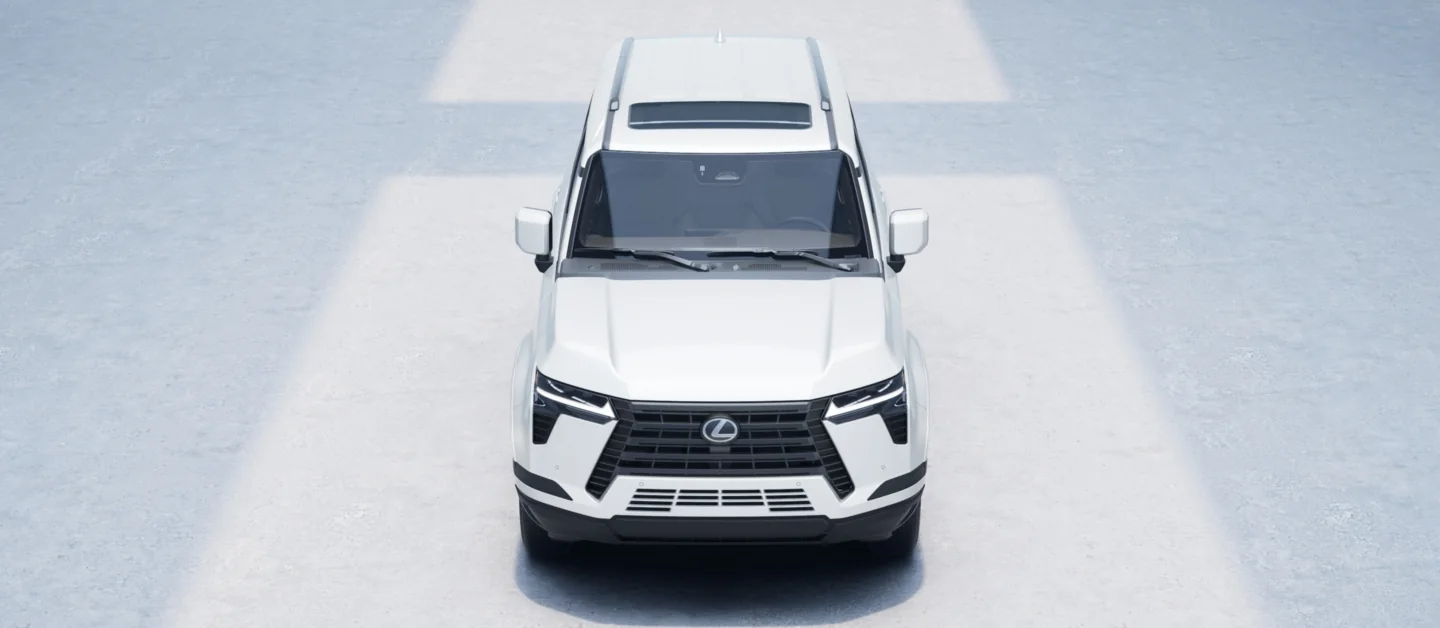 Lexus GX in white seen from the front and slightly above, in a studio