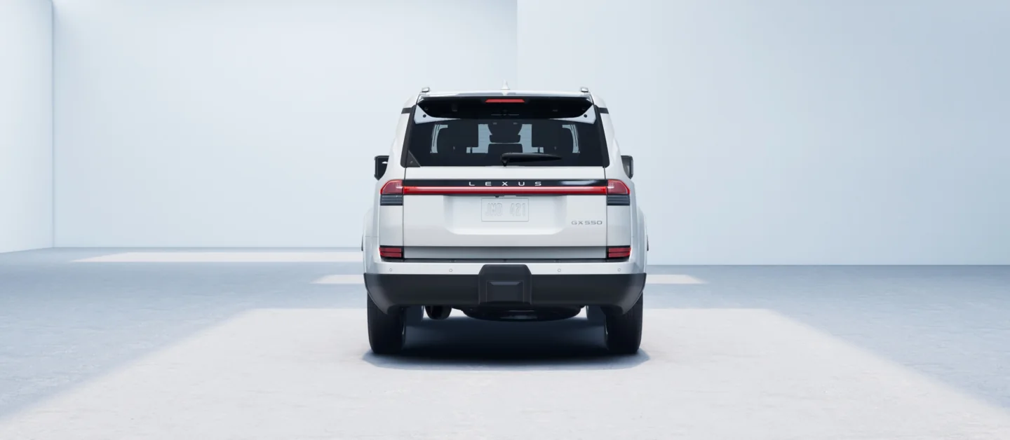 Lexus GX in white from directly behind, showing the full-width tail lamp