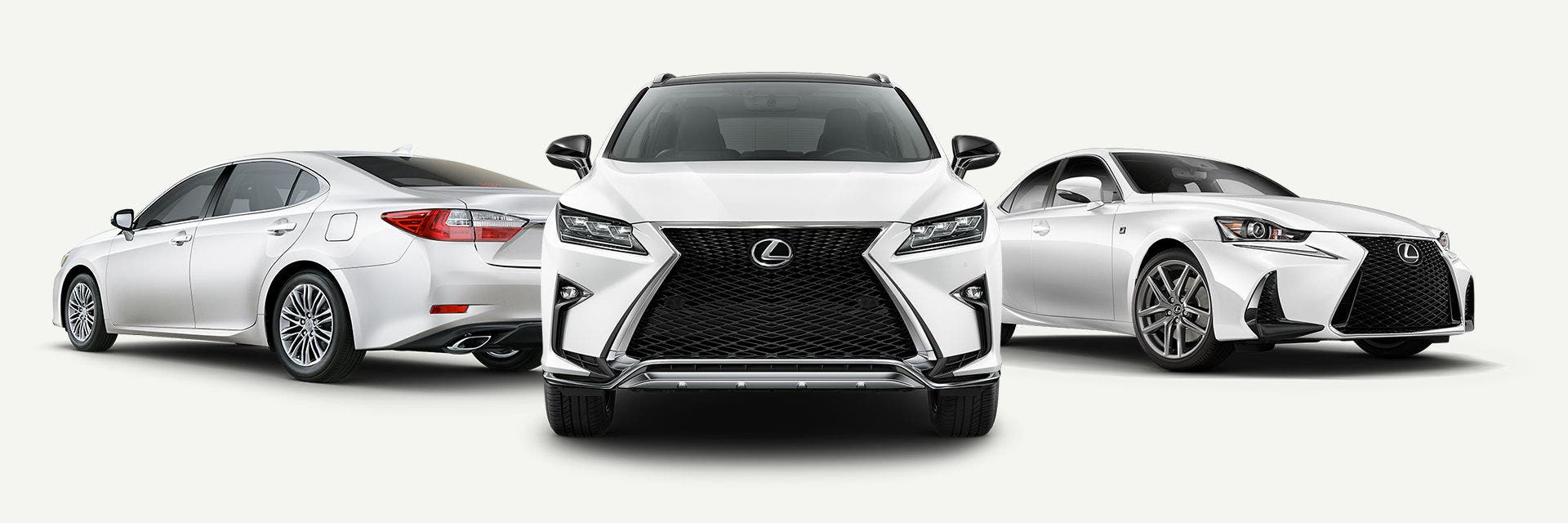 Three Lexus models in white lined up together, sedan through to SUV