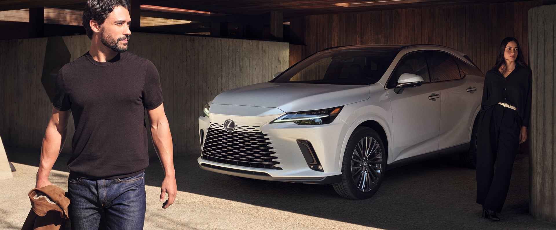 Lexus RX in white beneath a timber carport as two people walk past
