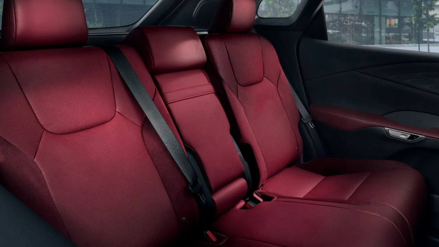 The rear seats of a Lexus RX in red leather, with room for three across the back
