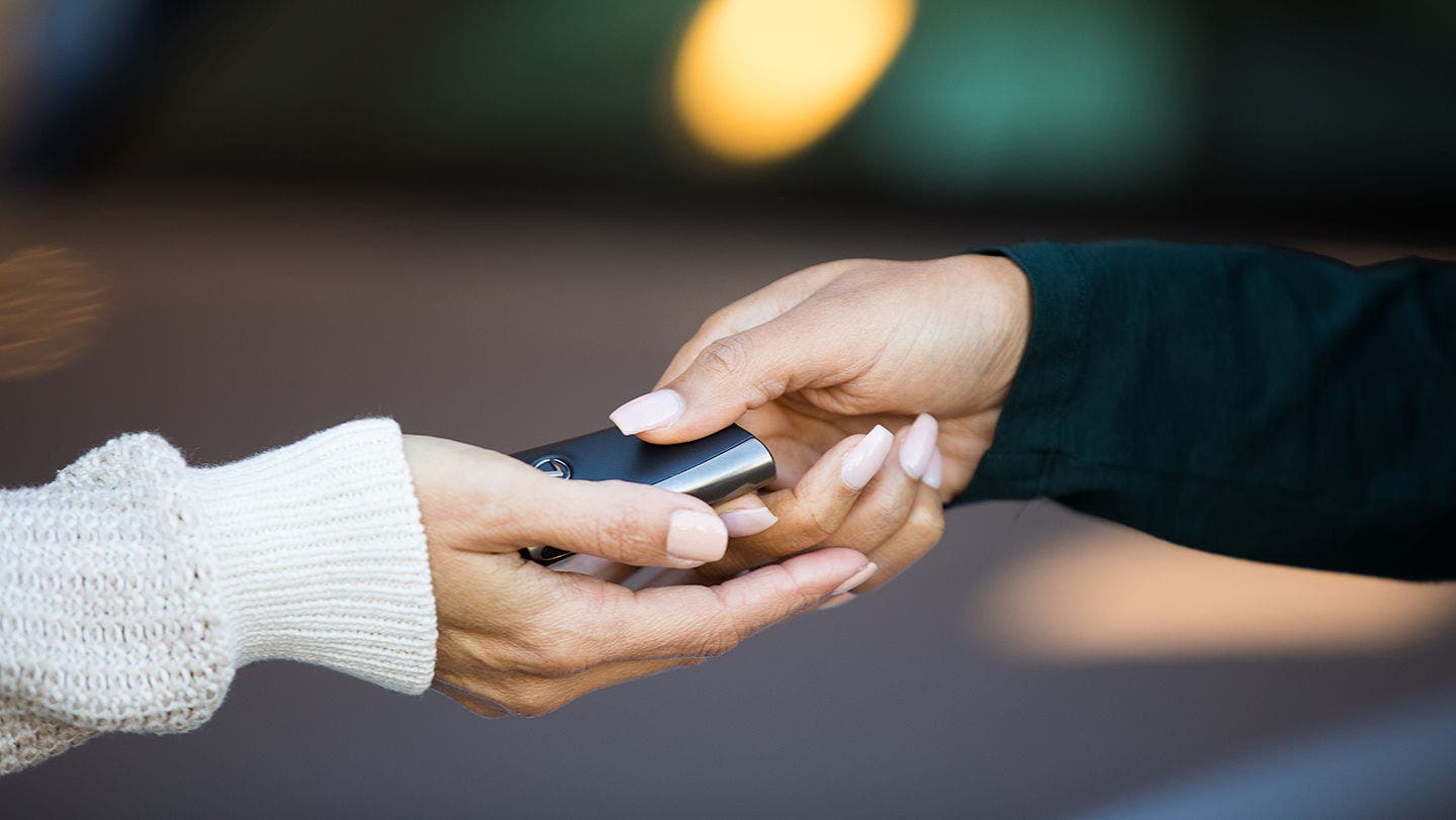 A Lexus key being handed back to its owner