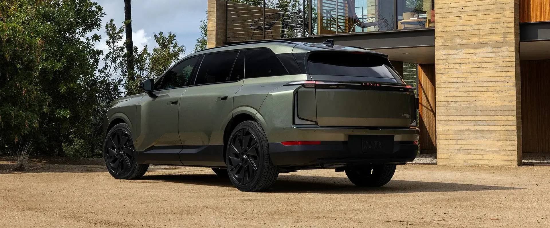 Lexus TZ in olive green, rear three-quarter view