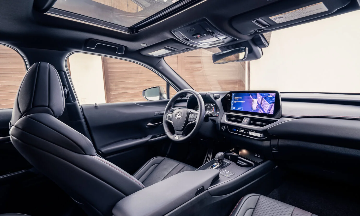 Lexus UX 300h F SPORT interior showing the dashboard, screen and front seats